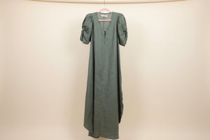 Green linen goddess dress with architectural sleeves made in Tulum mexico for vacation style 
