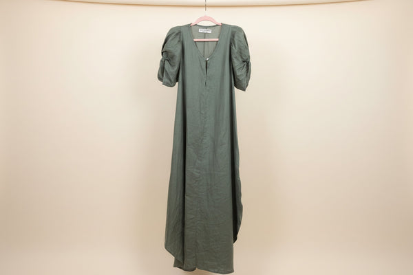 Green linen goddess dress with architectural sleeves made in Tulum mexico for vacation style 

