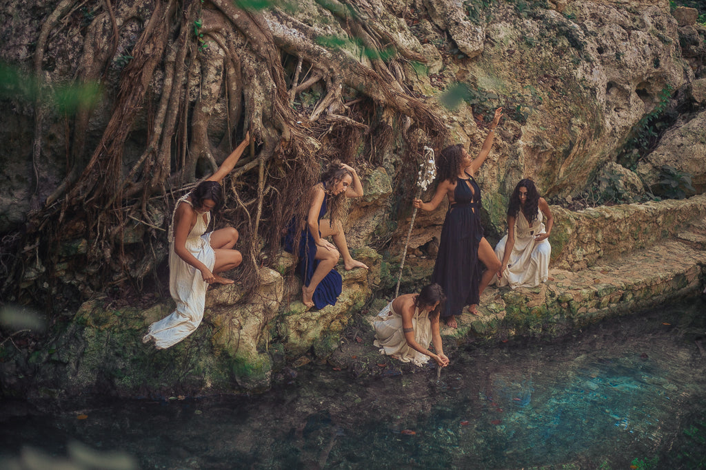 five women perform ritual at a cenote in Tulum, Mexico